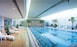 An Indoor Pool with Loungers